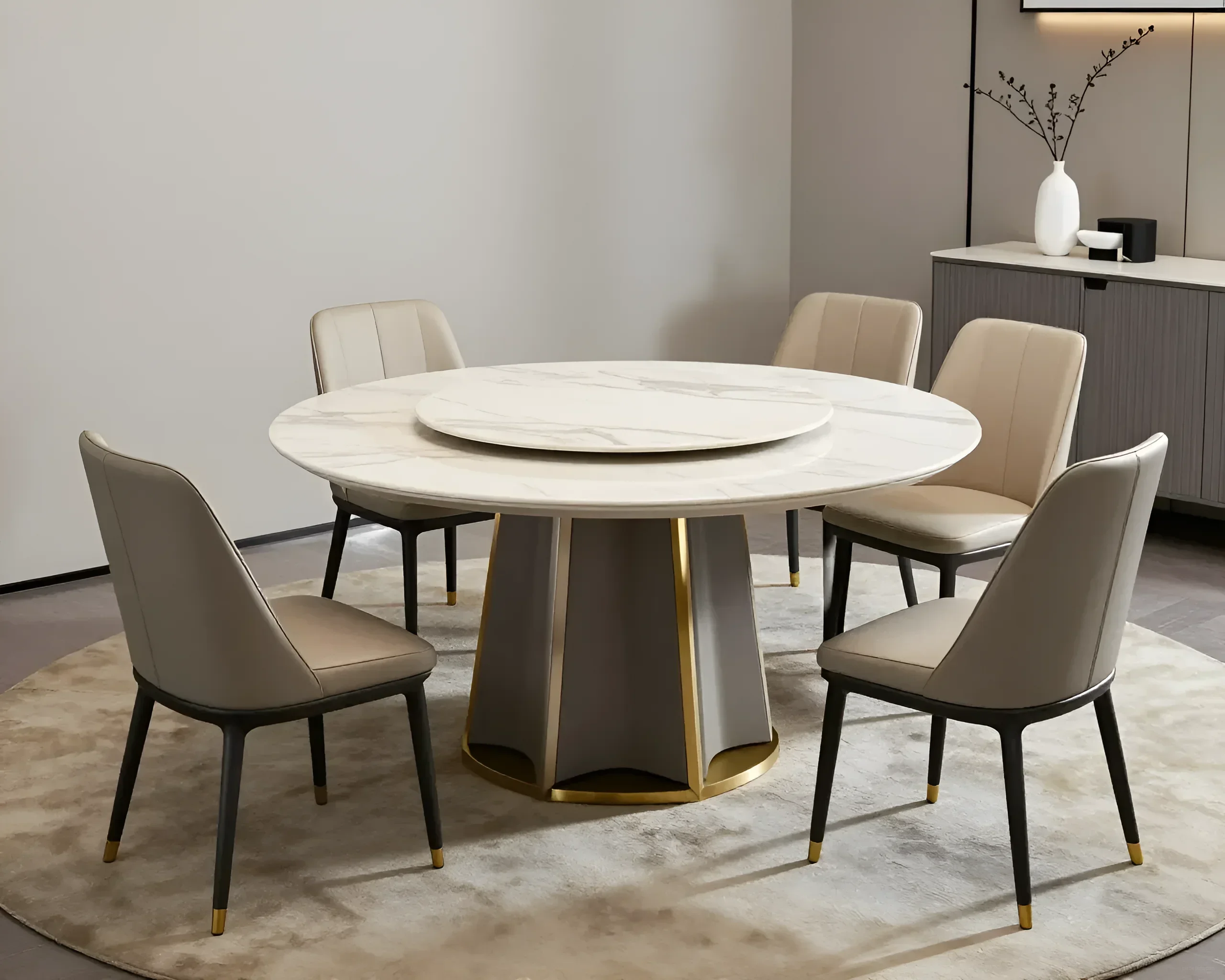 Modern round dining table with a marble top and a lazy susan, surrounded by elegant neutral-toned chairs.