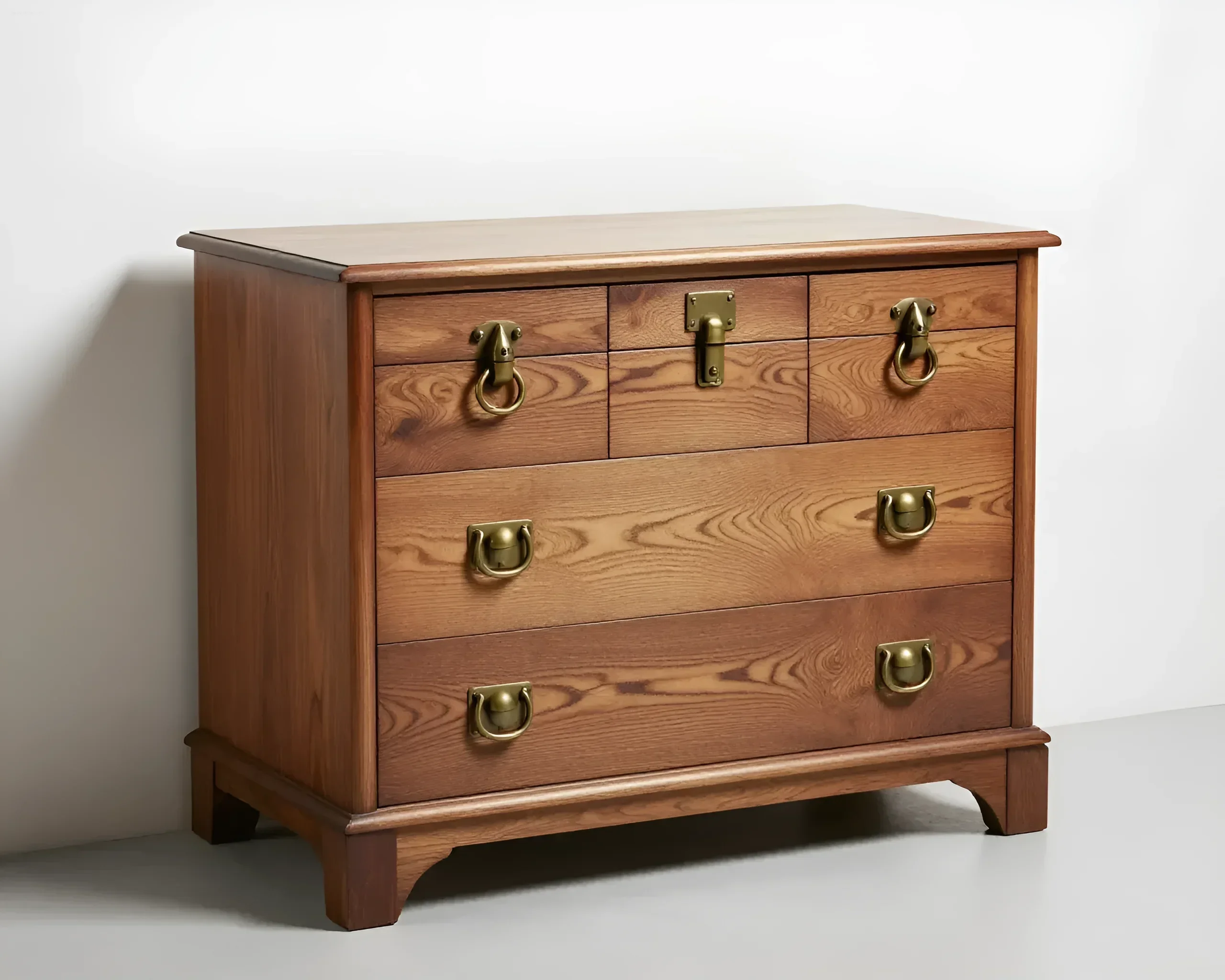 Wooden chest of drawers with five drawers and brass handles in vintage style