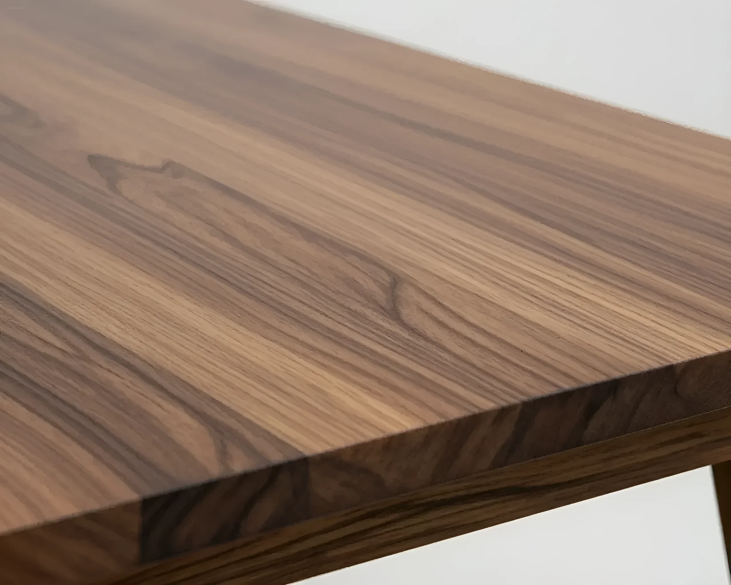 Close-up of the texture of a solid walnut tabletop with pronounced veins