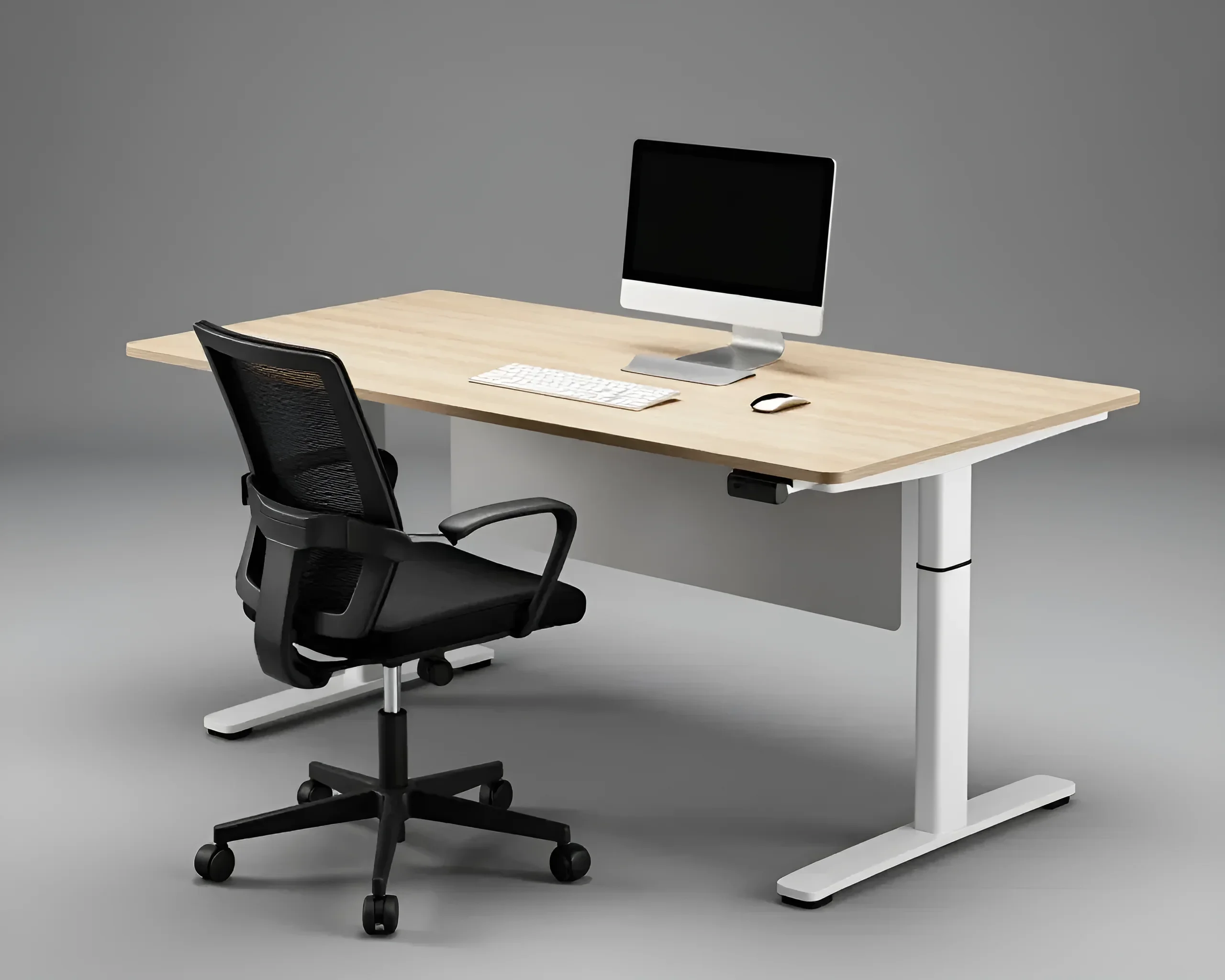 Modern height-adjustable office desk with a light wood tabletop, next to a black ergonomic chair, with a monitor, keyboard, and mouse on the desk