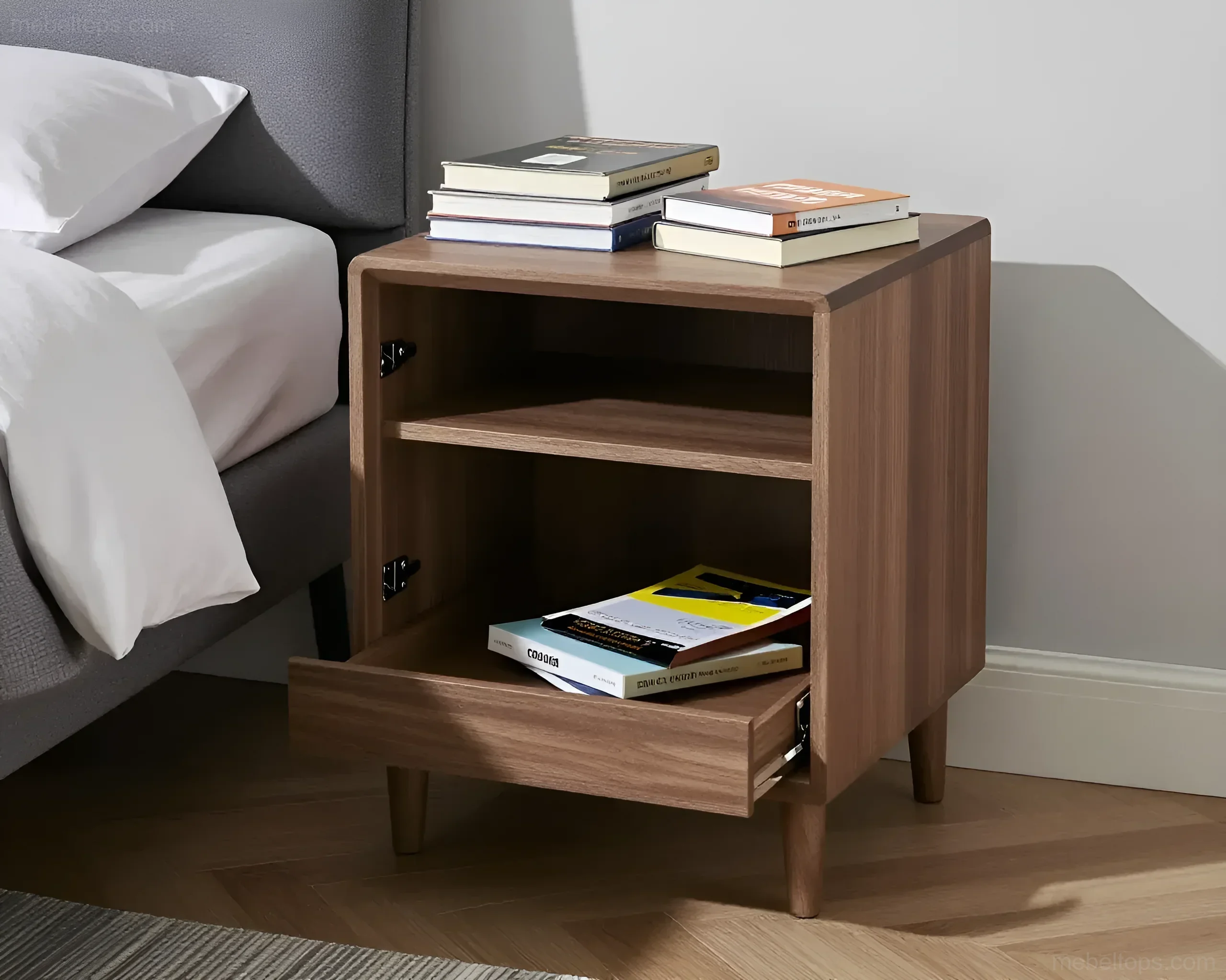Modern wooden bedside table with a drawer and shelf, placed next to a bed